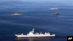 FILE - Warships sail in the Gulf of Oman during the second day of joint Iran, Russia and China naval war games on Dec. 28, 2019. Similar drills took place this week. (Iranian army via AP)