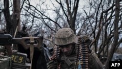 [FILE] A Ukrainian soldier prepares ammunition to fire at Russian front-line positions near Bakhmut, in Ukraine's Donetsk region, March 11, 2023.