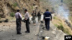 FILE - Security personnel inspect the site of a suicide attack in the Shangla district of Pakistan's Khyber Pakhtunkhwa province on March 26, 2024. Five Chinese nationals working on a construction site were killed along with their driver by a suicide bomber.