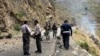 Security personnel inspect the site of a suicide attack in the Shangla district of Pakistan's Khyber Pakhtunkhwa province on March 26, 2024. Five Chinese nationals working on a construction site were killed along with their driver by a suicide bomber.