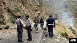 Security personnel inspect the site of a suicide attack in the Shangla district of Pakistan's Khyber Pakhtunkhwa province on March 26, 2024. Five Chinese nationals working on a construction site were killed along with their driver by a suicide bomber.