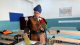 Nazim Cihan, 48, holds his bird as he votes at a polling station in Istanbul, Turkey, May 14, 2023.