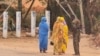 A soldier talks to women on a street in Khartoum on June 6, 2023, as fighting continues in war-torn Sudan. 