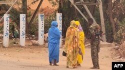 A soldier talks to women on a street in Khartoum on June 6, 2023, as fighting continues in war-torn Sudan. 