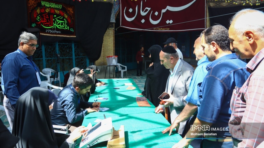 Iranian Jews are photographed by Iranian state media voting at Isfahan's Al Aqsa Mosque in the second round of the Iranian presidential election on July 5, 2024. The ballot box can be seen in the center of the image. (Source: IMNA) 