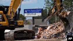 Workers continue demolition of the First Baptist Church where a gunman killed more than two dozen worshipers in 2017, in Sutherland Springs, Texas, Aug. 12, 2024.