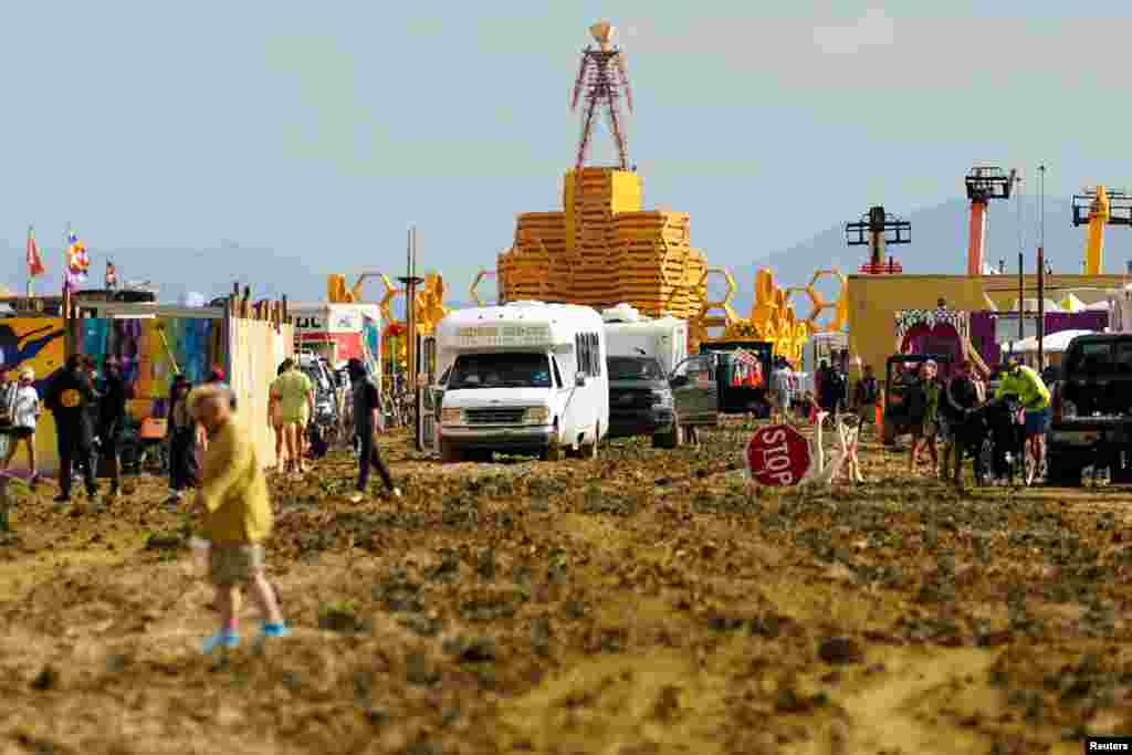 The Man structure, which is normally burned on Saturday night, looms over the Burning Man encampment after a severe rainstorm left tens of thousands of revelers stranded in mud in the Nevada desert, Sept. 3, 2023. (USA Today Network)