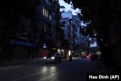 Road lights are seen switched off to save energy in Hanoi, Vietnam, on June 8, 2023. (AP Photo/Hau Dinh)