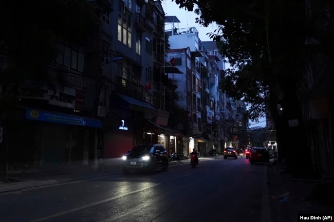 Road lights are seen switched off to save energy in Hanoi, Vietnam, on June 8, 2023. (AP Photo/Hau Dinh)