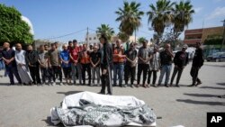 Palestinians prayer next to the bodies of their relatives who were killed in an Israeli airstrike in Gaza Strip, at the Al Aqsa hospital in Deir al Balah, Gaza, May 4, 2024. 