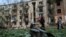 Local residents walk near an apartment building damaged by a Russian airstrike in Kharkiv, Ukraine, May 5, 2024.