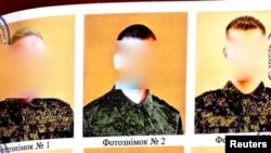 FILE - A scan of a document with a lineup of Russian soldiers suspected in a spree of sexual violence near Kyiv, Ukraine, in March 2022. (Ukraine's Prosecutor General's office/handout via Reuters; images obscured at source). 