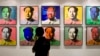 FILE - A visitor looks at a 10-piece set paper screenprint of Mao Zedong by Andy Warhol, which is part of Warhol's series of the late Chinese leader, displayed at the Hong Kong Convention and Exhibition Center, May 26, 2008. 
