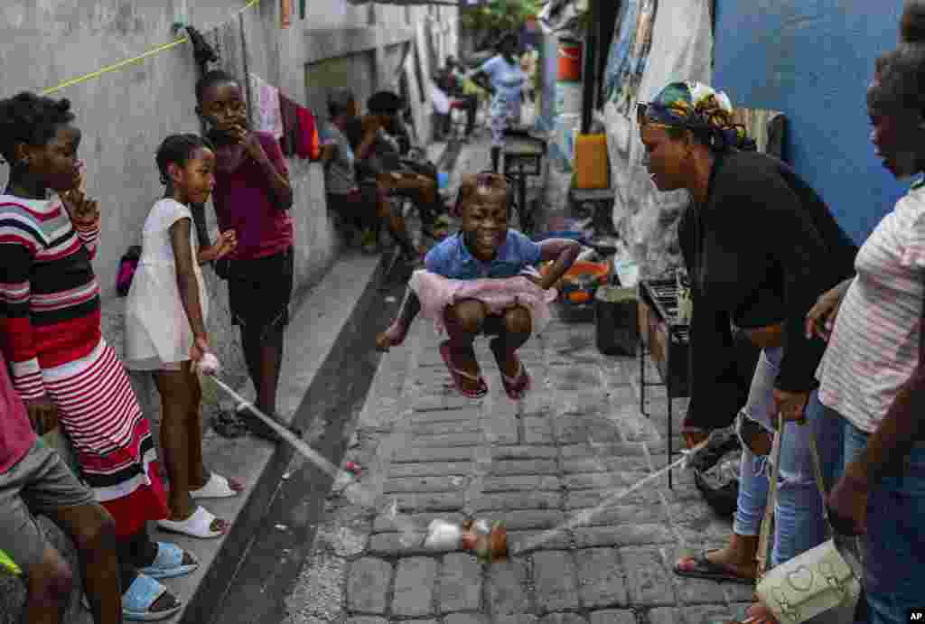 A girl plays a jump rope game at a school housing locals displaced by gang violence in Port-au-Prince, Haiti, May 15, 2024.