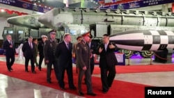 FILE - North Korean leader Kim Jong Un, right, and Russia's Defense Minister Sergei Shoigu visit an exhibition of armed equipment in this image released by North Korea's Korean Central News Agency on July 27, 2023. (KCNA via Reuters) 