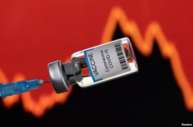 FILE - A vial of "VACCINE Coronavirus COVID-19" is seen in front of a stock graph in this illustration taken on January 17, 2022. (REUTERS/Dado Ruvic/Illustration)