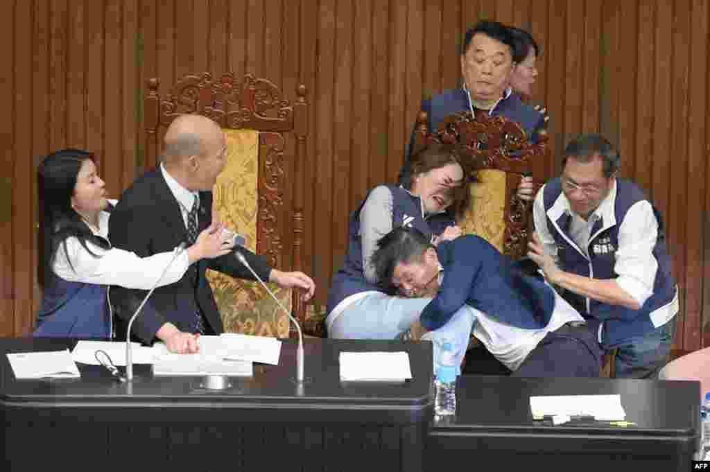 Taiwan&#39;s lawmakers exchange blows during voting for a reform bill in parliament, in Taipei.