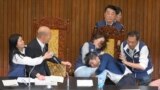 Taiwan's lawmakers exchange blows during voting for a reform bill in parliament, in Taipei.