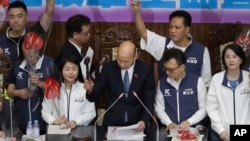 President of the Legislative Yuan Han Kuo-yu, center, knocks down the gavel and passes a bill during both ruling and opposition parties demonstrate at the legislative chamber building in Taipei, Taiwan, May 28, 2024.