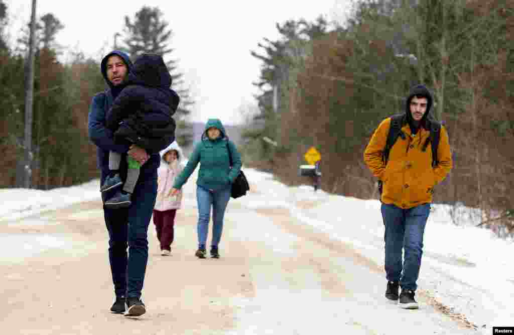 Asylum seekers who stated they were from Turkey, walk down Roxham Road to cross into Canada from the U.S. in Champlain, New York, Feb. 25, 2023.