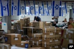 Volunteers work at a donation center to support Israeli soldiers and the 200,000 Israelis evacuated from their homes in the north and south during the Israel-Hamas war, in Tel Aviv, Israel, Oct. 25, 2023.
