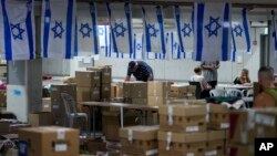 FILE - Volunteers work at the Brothers in Arms aid organization's headquarters in Tel Aviv, Israel, on Oct. 25, 2023. Brothers in Arms will accept on behalf of the people of Israel an award from the Halifax International Security Forum in Halifax, Nova Scotia, Canada, on Nov. 18.