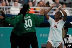 Azenaide Carlos, left, and Eliane Paulo of Angola celebrate a goal during a women's handball match between Angola and Netherlands, at the 2024 Summer Olympics, July 25, 2024, in Paris. Netherlands won 34-31.