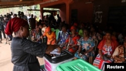 A voter casts her ballot during Nigeria's Presidential election, in Agulu, Anambra state, Nigeria, Feb. 25, 2023.