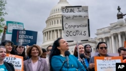 Analilia Mejia of the Center for Popular Democracy, center, joins other activists calling for ethics reform in the U.S. Supreme Court, at the Capitol in Washington, May 2, 2023. 