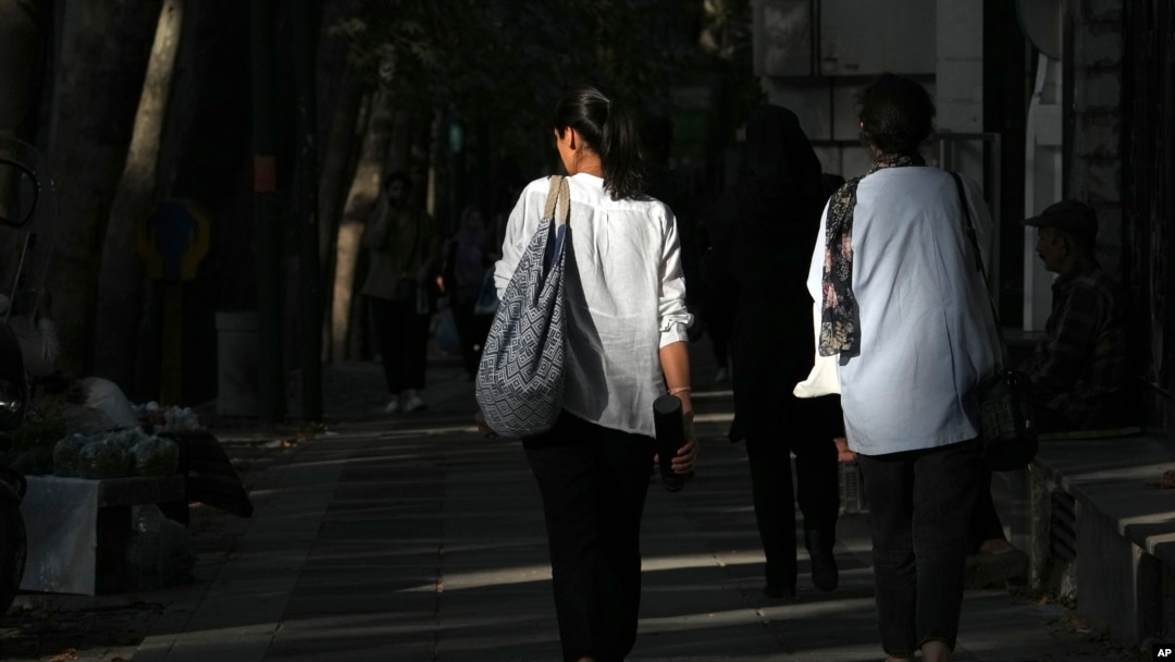 Iranian women walk in Tehran, Iran, Aug. 5, 2023. These days, with uncovered women a common sight on Tehran streets, authorities have begun raiding companies where women employees or customers have been seen without the headscarf, or hijab.