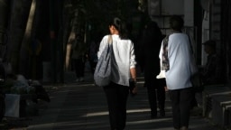 Iranian women walk in Tehran, Iran, Aug. 5, 2023. These days, with uncovered women a common sight on Tehran streets, authorities have begun raiding companies where women employees or customers have been seen without the headscarf, or hijab.