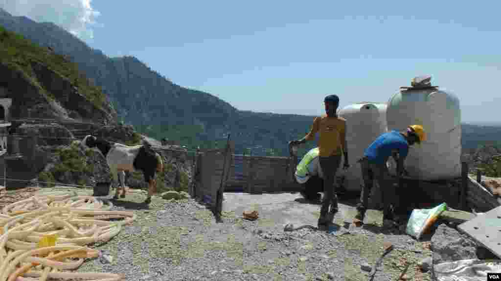 Laborers taking a water break at a project site at Udhampur-Srinagar-Baramulla Rail Line in Kashmir. (Bilal Hussain/VOA)