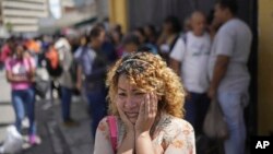 Maritza Fernández stands outside the Boleita National Police detention center after her partner was detained during opposition protests against the official results of the presidential election, in Caracas, Venezuela, Aug. 1, 2024.