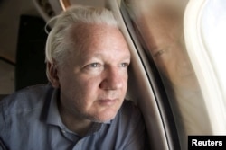 WikiLeaks founder Julian Assange looks out a plane window as he approaches Bangkok airport for a layover, according to a post by Wikileaks on X, June 25, 2024.