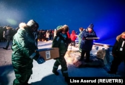 Representatives from many countries and universities arrive in the Svalbard's global seed vault with new seeds, in Longyearbyen, Norway February 25, 2020. (NTB Scanpix/Lise Aserud via REUTERS )