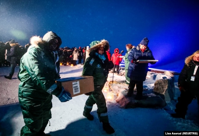 Representatives from many countries and universities arrive in the Svalbard's global seed vault with new seeds, in Longyearbyen, Norway February 25, 2020. (NTB Scanpix/Lise Aserud via REUTERS )