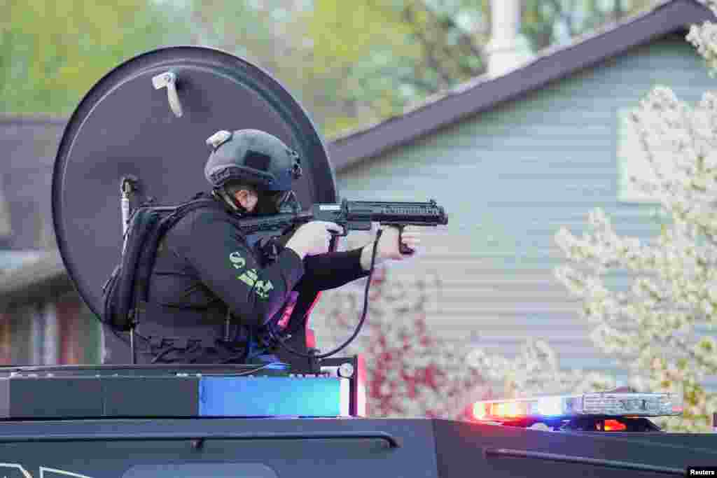 A SWAT officer fires tear gas towards the demonstrators as they attend a protest held after a grand jury voted against indicting police officers in the fatal shooting of unarmed Black man Jayland Walker, in Akron, Ohio, April 19, 2023.&nbsp;