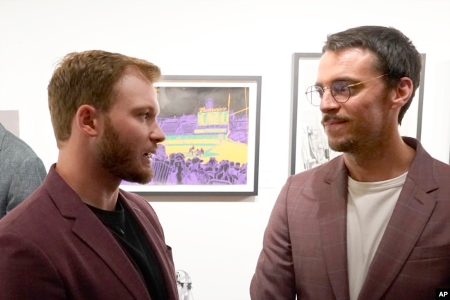 HappChicago Cubs left fielder Ian Happ, left, and British artist Pat Vale talk during a gallery opening of Vale's work. (AP Photo/Charles Rex Arbogast)