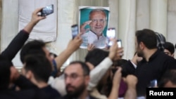 A poster of Iran's President-elect Masoud Pezeshkian is seen during a gathering with his supporters at the shrine of Iran's late leader Ayatollah Ruhollah Khomeini in the south of Tehran, July 6, 2024. (Majid Asgaripour/West Asia News Agency via Reuters)