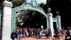 FILE - In this Aug. 15, 2017, photo, students walk on the University of California, Berkeley campus in Berkeley, Calif. 
