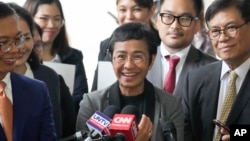 Journalist Maria Ressa, 2021 Nobel Peace Prize winner and Rappler CEO, gestures as she talks to reporters after being acquitted by the Pasig Regional Trial Court in a tax evasion case in Pasig city, Philippines, Sept. 12, 2023.