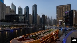 A floating restaurant is seen decked up as it is is anchored at Dubai Marina Walk in Dubai, United Arab Emirates, Aug. 13, 2024.