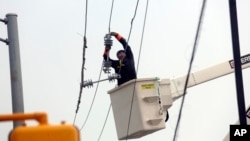 Utility crews work to restore electricity in Houston, July 11, 2024. 