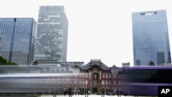 Vehicles pass by the Tokyo Station Friday, May 26, 2023, in Tokyo. A strong earthquake shook eastern Japan on Friday evening, but there was no tsunami warning.
