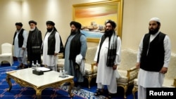FILE - Members of the Taliban's peace negotiation team attend a meeting amid talks between Taliban and the Afghan government, in Doha, Nov. 21, 2020. Taliban says it will send a delegation to the two-day United Nations conference on Afghanistan, scheduled in Doha, June 30.