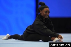 FILE - Simone Biles stretches during a training session ahead of the U.S. Gymnastics Olympic Trials on June 26, 2024, in Minneapolis. (AP Photo/Abbie Parr)