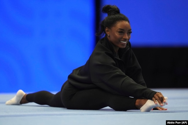 FILE - Simone Biles stretches during a training session ahead of the U.S. Gymnastics Olympic Trials on June 26, 2024, in Minneapolis. (AP Photo/Abbie Parr)