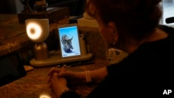 Deanna Dezern, 83, interacts with her ElliQ, a tabletop device that uses artificial intelligence to conduct human-like conversations, inside her home in Tamarac, Florida, Dec. 7, 2023.