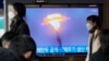A North Korean missile launch is shown during a TV news program at the Seoul Railway Station in Seoul, South Korea, March 28, 2023. North Korea on Tuesday unveiled smaller nuclear warheads, state media said.