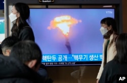 FILE - A North Korean missile launch is shown during a TV news program at the Seoul Railway Station in Seoul, South Korea, March 28, 2023.